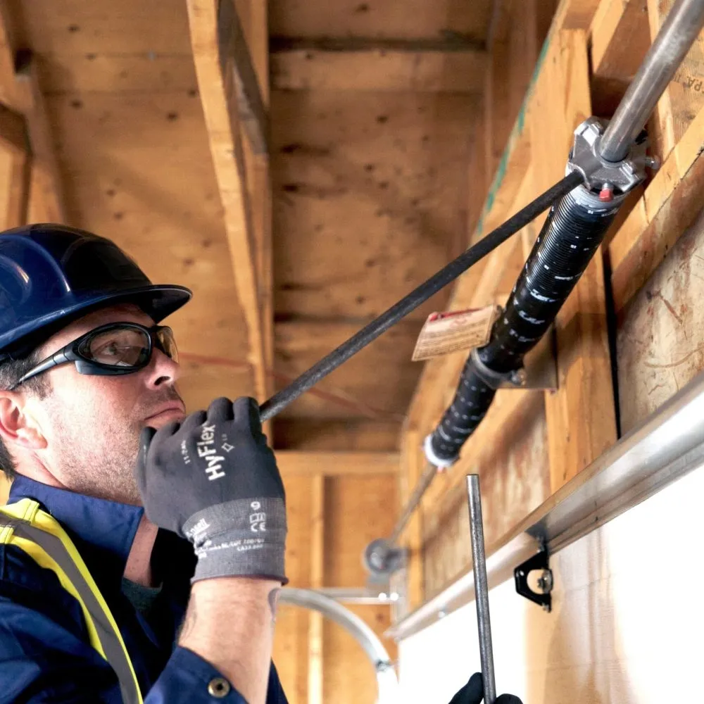 professional garage door spring repair Las Vegas NV technician working