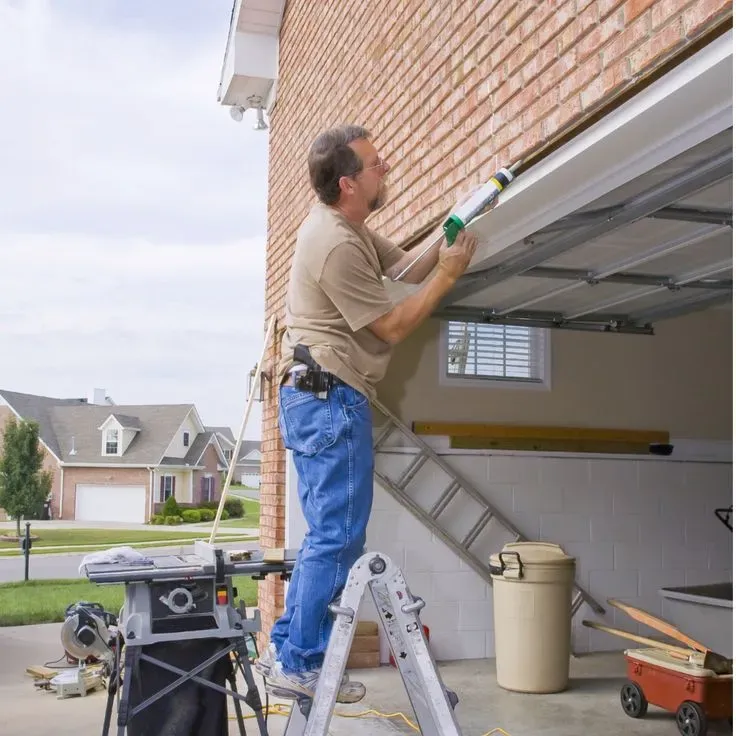 as Vegas garage door maintenance service lubricating garage door tracks