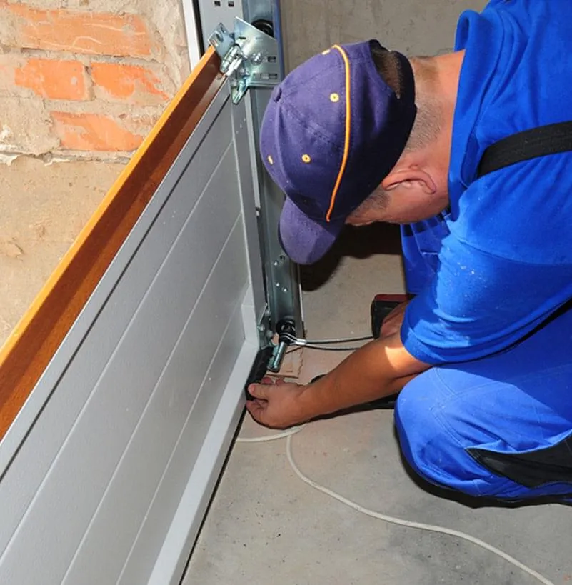 panel by panel garage door replacement Las Vegas technician working