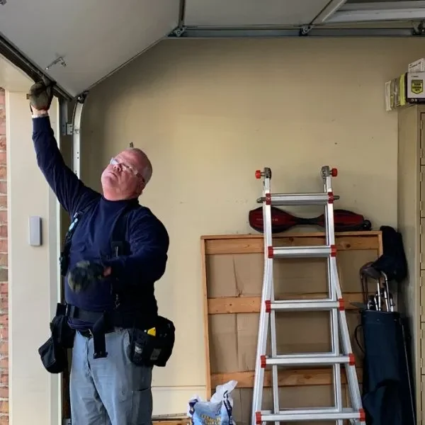 garage door maintenance Las Vegas technician adjusting springs