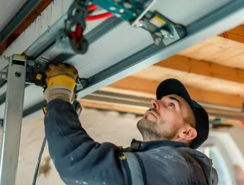 fixing rattling garage door tracks service Las Vegas technician working