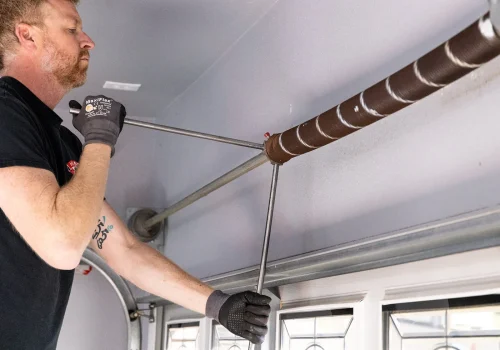 garage door spring repair Las Vegas technician replacing torsion spring