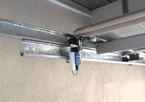 garage door safety sensor repair Las Vegas technician fixing sensors